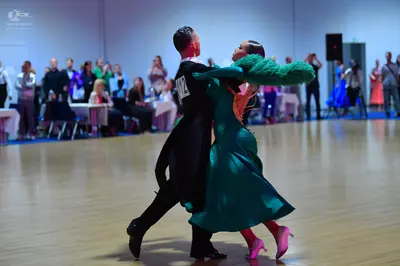 Dancesport competitor #12: Male dancer: black ballroom tailcoat, white shirt, and black trousers