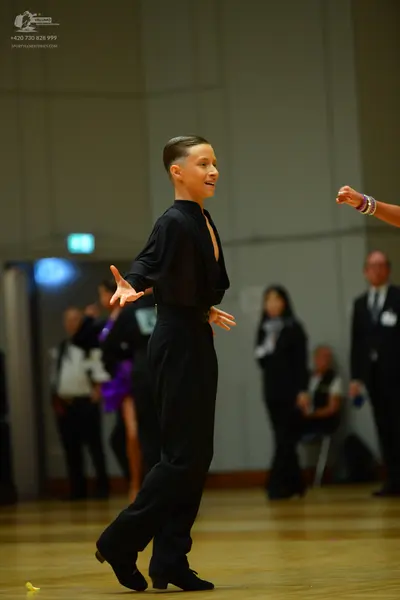 Dancesport competitor: Male dancer: black long-sleeve shirt and black trousers