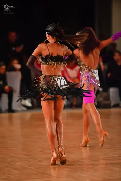 Dancesport competitor #22: Female dancer 1: gold and black sequined Latin dance costume with black fringe/f