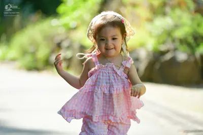 Dancesport competitor: Female dancer: pink and white checkered ruffled outfit with a white ruffled bonn