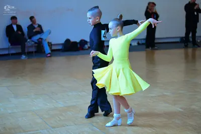 Dancesport competitor: Male dancer: black long-sleeved shirt and black trousers