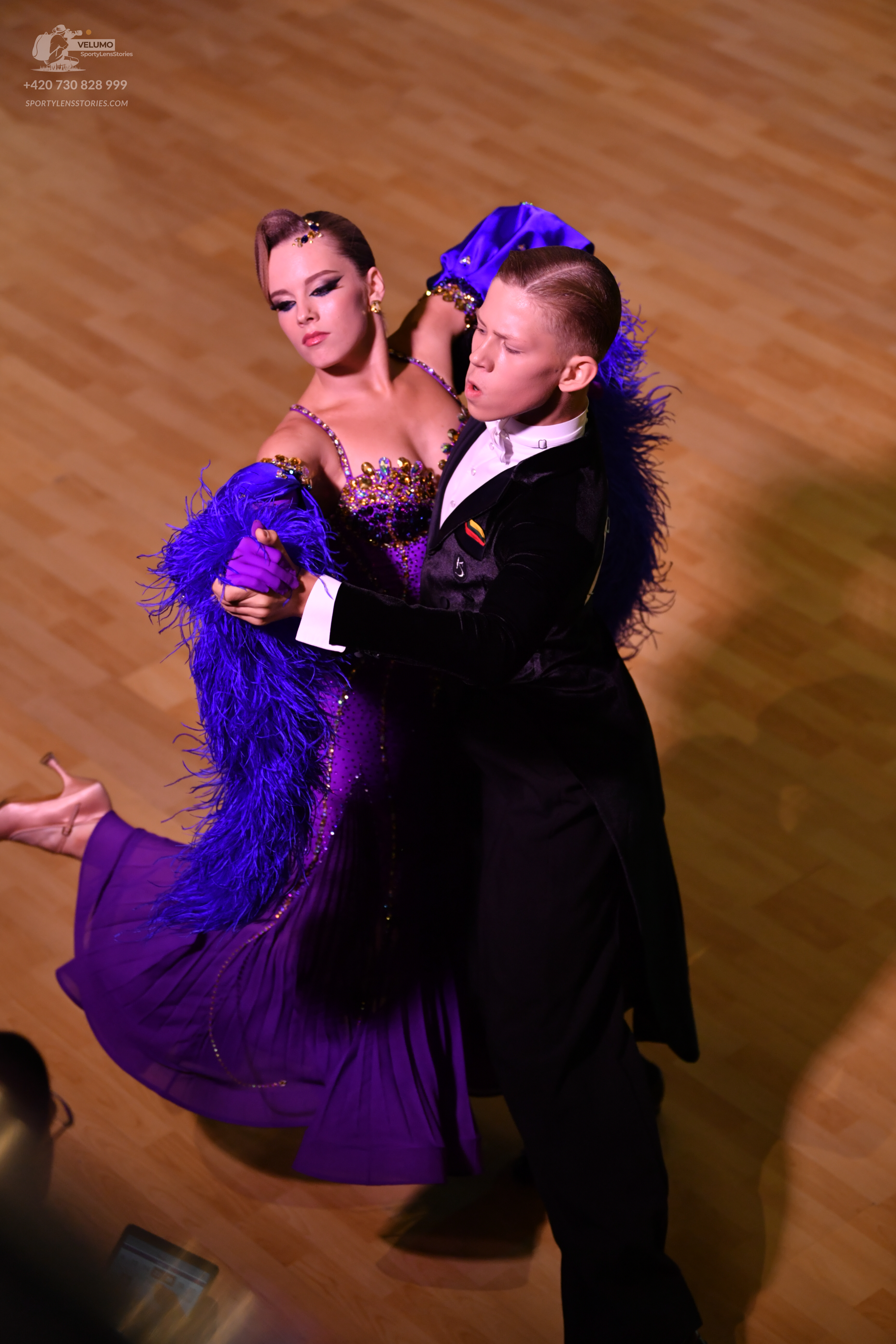 Dancesport competitor: ** Red Latin Dress
*   **Fabric:** Primarily satin, with shimmering sequins embe