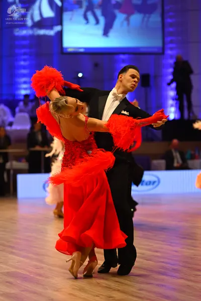 Dancesport competitor: Male dancer: black suit with a white shirt and white bowtie
