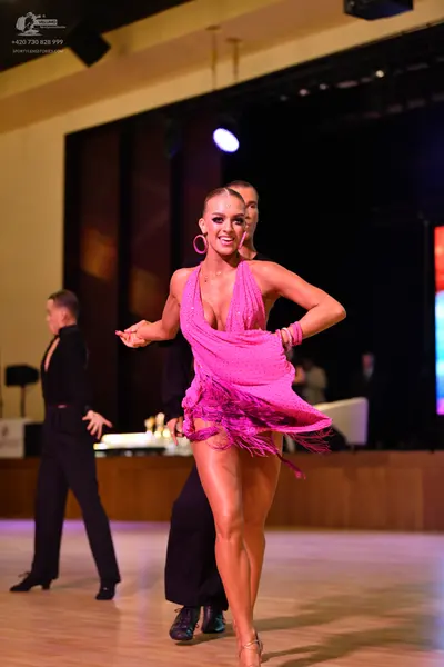 Dancesport competitor: ** Black tailsuit with sequin lapels