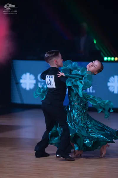 Dancesport competitor: Male dancer: black long-sleeved top and black trousers