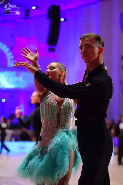 Dancesport competitor: Male dancer: black long-sleeved shirt and black trousers