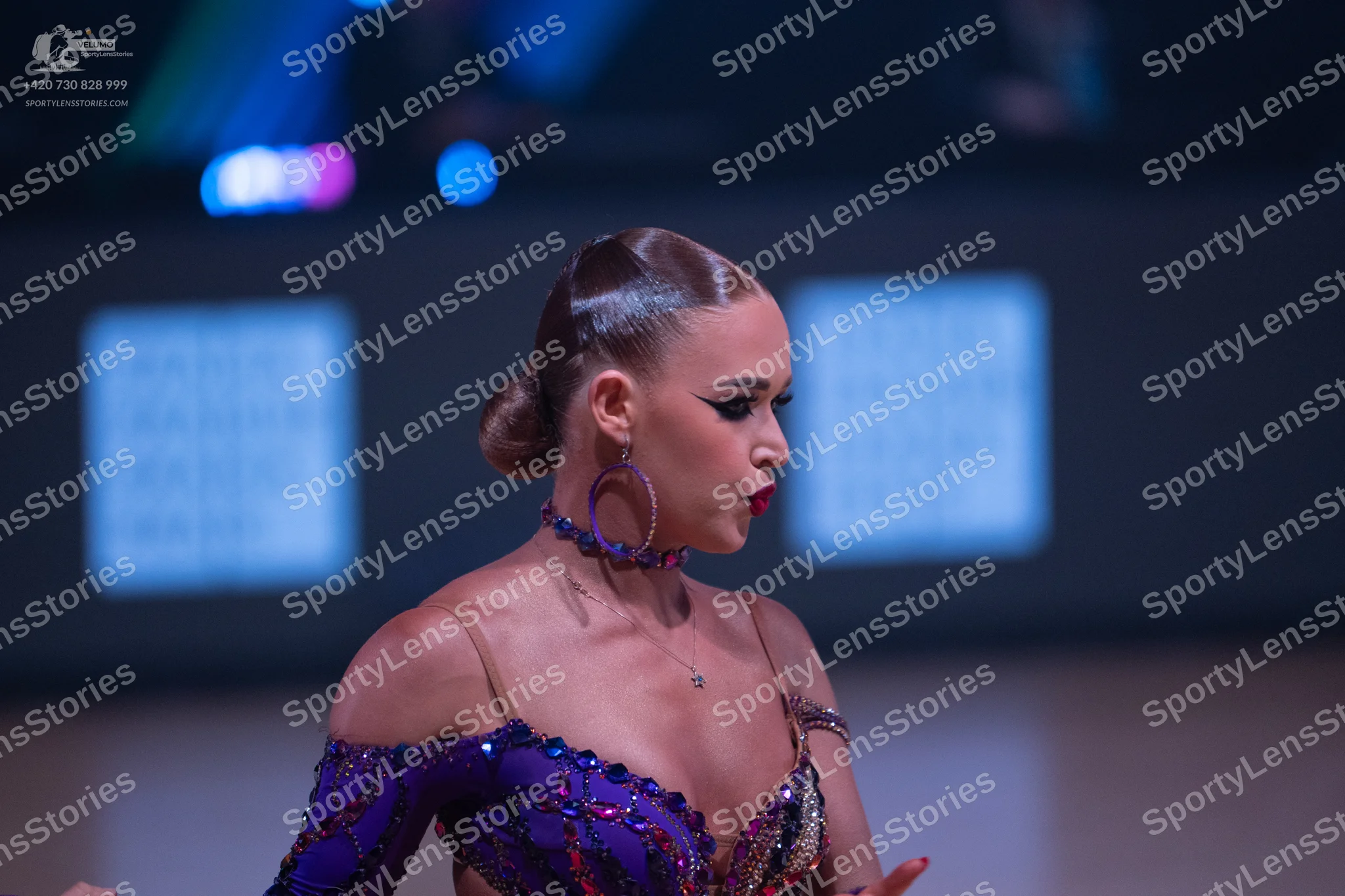 Dancesport competitor: Female dancer: purple latin dress heavily embellished with sequins and beads, fe