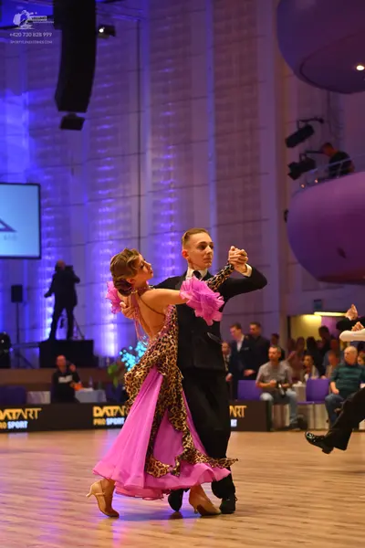 Dancesport competitor: Male dancer: black suit with a white shirt and black tie