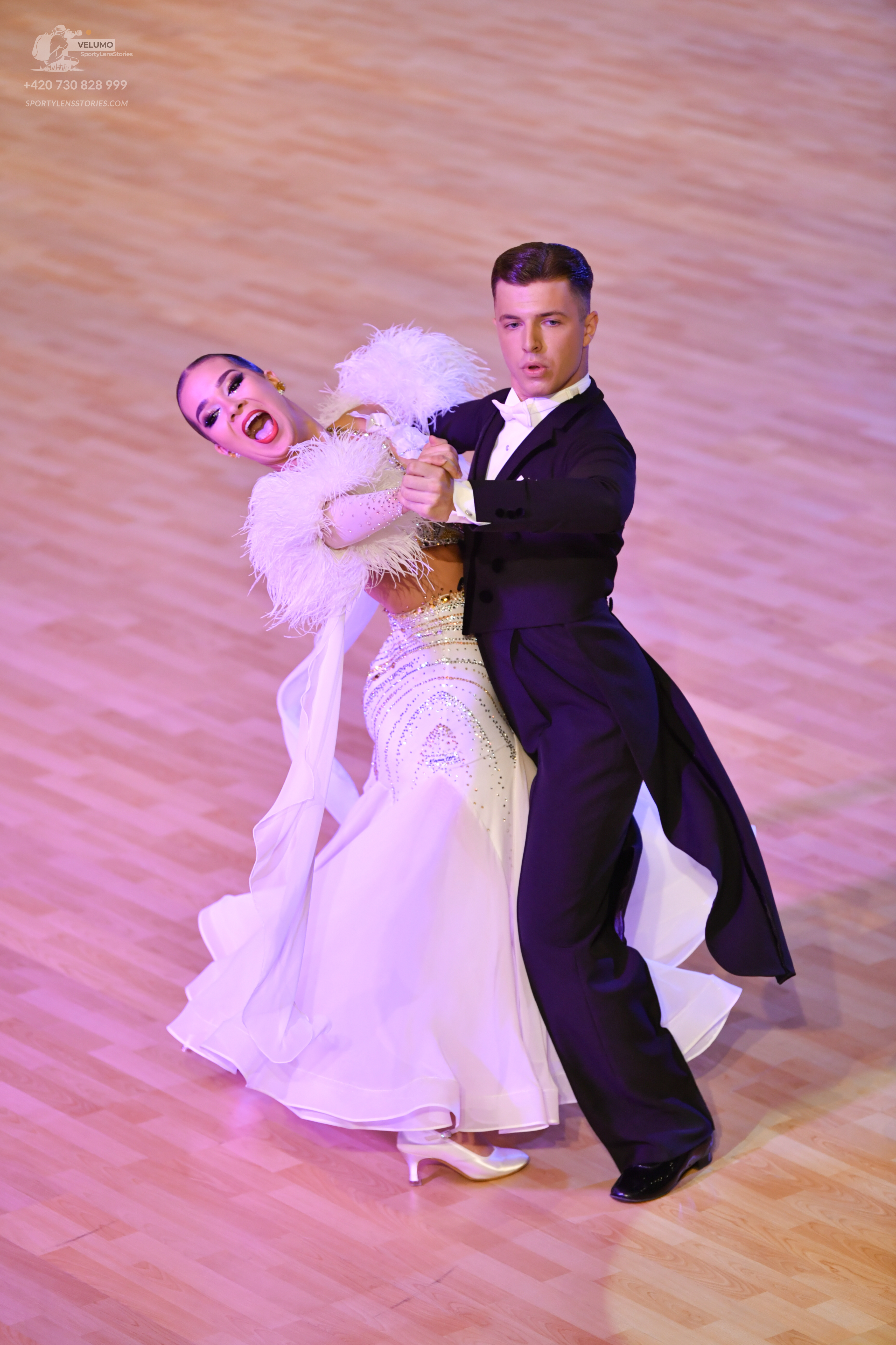 Dancesport competitor: ** 
*   **Male:** Black tailsuit with a white sequin lapel and tuxedo shirt
