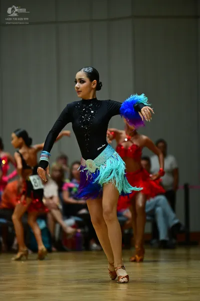 Dancesport competitor #81: Primary dancer: black long-sleeved bodysuit with sequin chest details, a light b