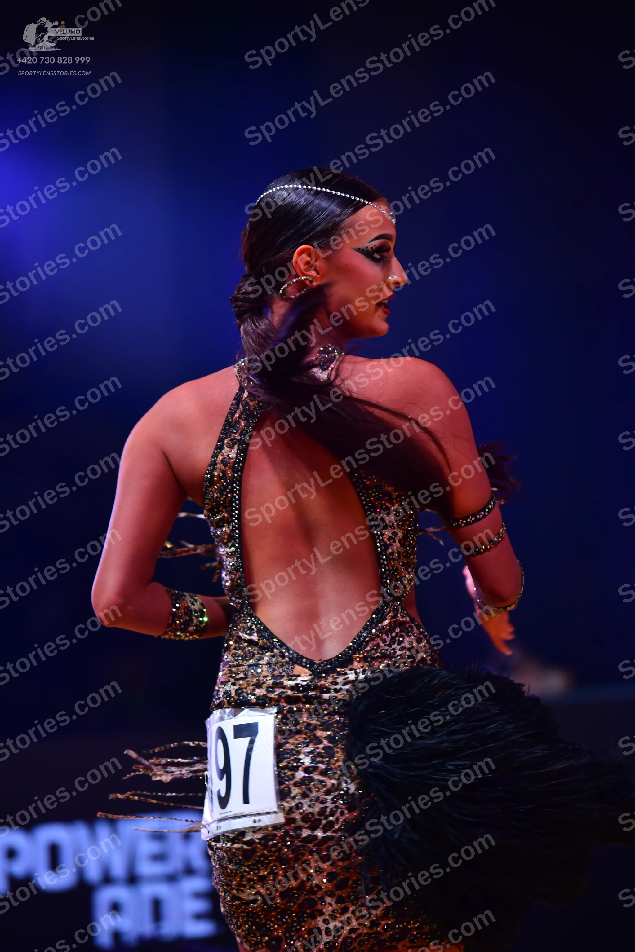 Dancesport competitor: Female dancer: leopard print Latin dress, backless, with black feather or fringe