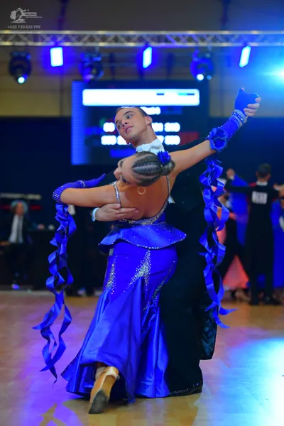 Dancesport competitor: Male dancer: black suit with a white shirt and white bow tie