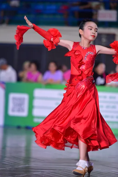 Dancesport competitor: ** Female: Red Latin dress