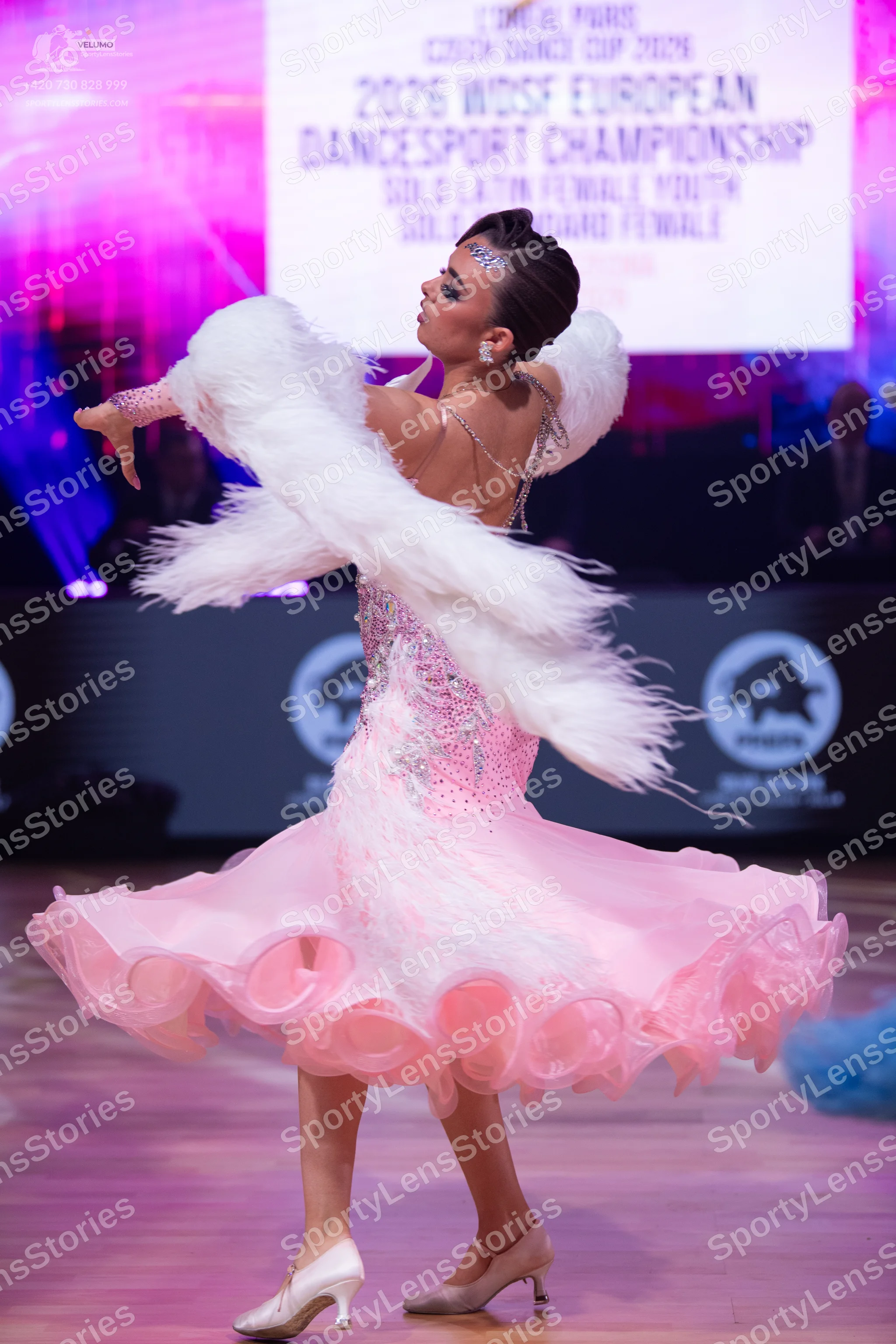Dancesport competitor: Female dancer: light pink ballroom dress with sequins and a voluminous, ruffled