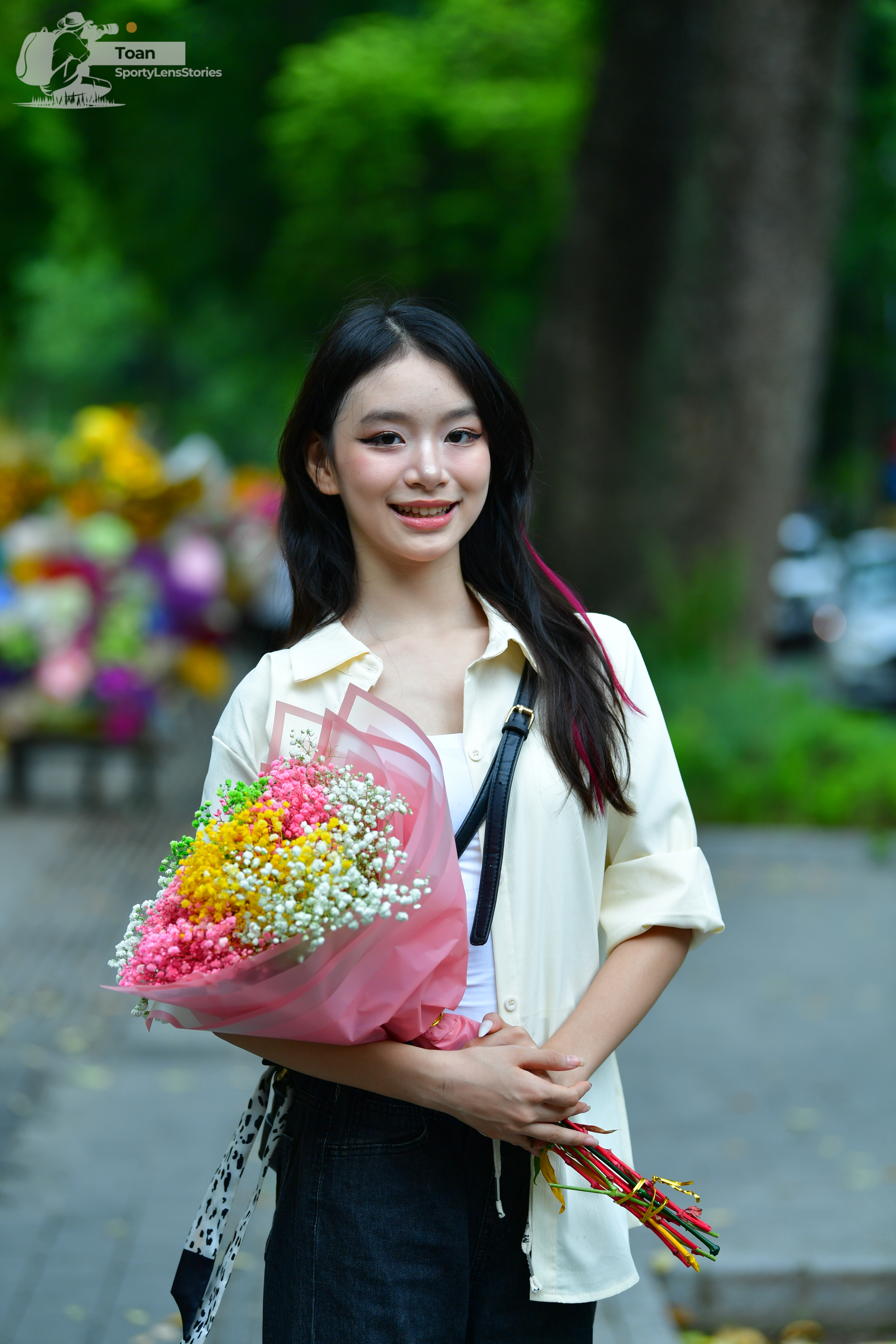 Dancesport competitor: Female dancer: cream-colored short-sleeved button-down shirt and black pants