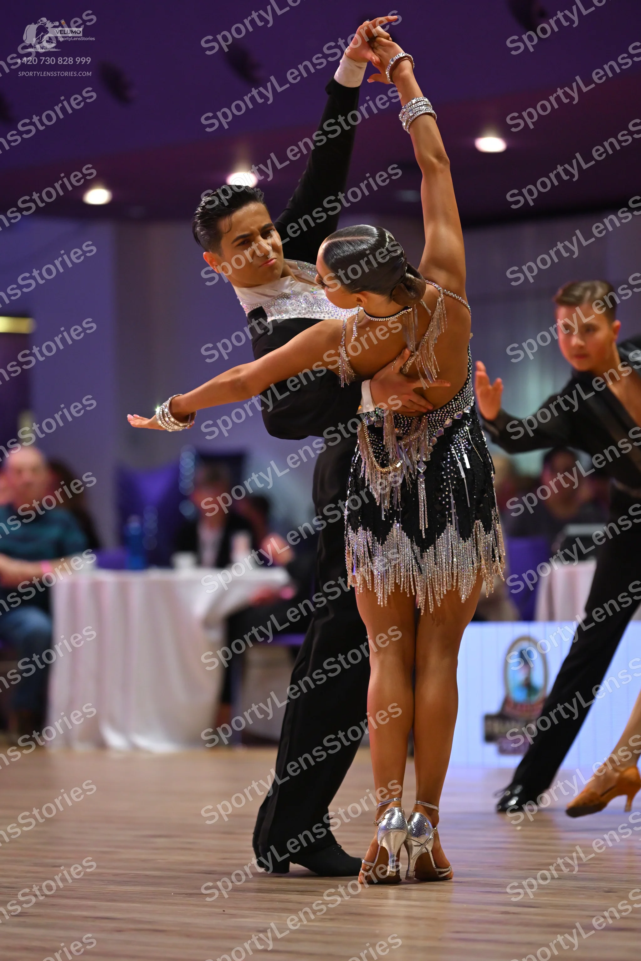 Dancesport competitor: Male dancer: black dance suit with a white sequined chest area
