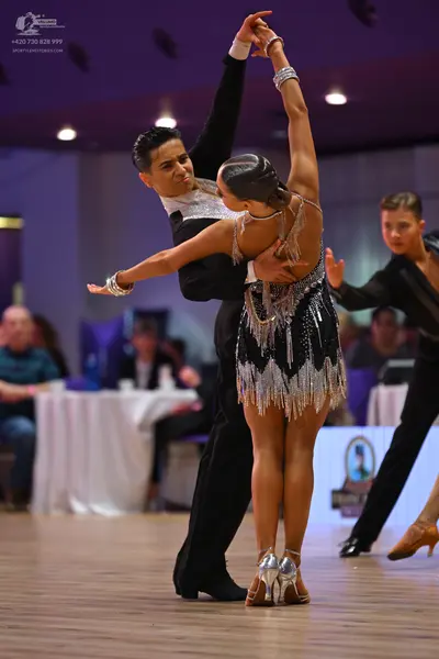 Dancesport competitor: Male dancer: black dance suit with a white sequined chest area