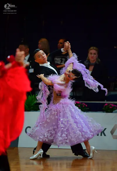 Dancesport competitor: Male dancer: black suit with a white shirt and white bow tie