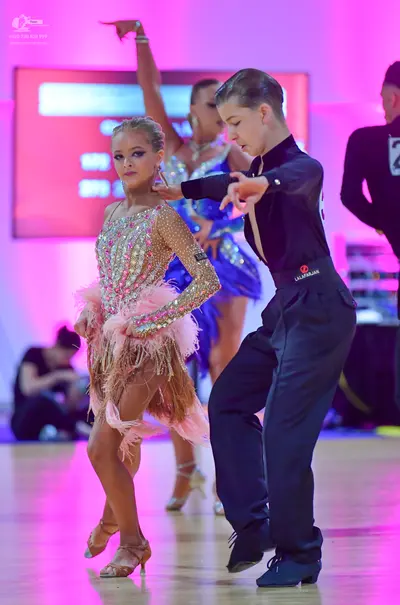 Dancesport competitor: Male dancer: black long-sleeved shirt and black trousers