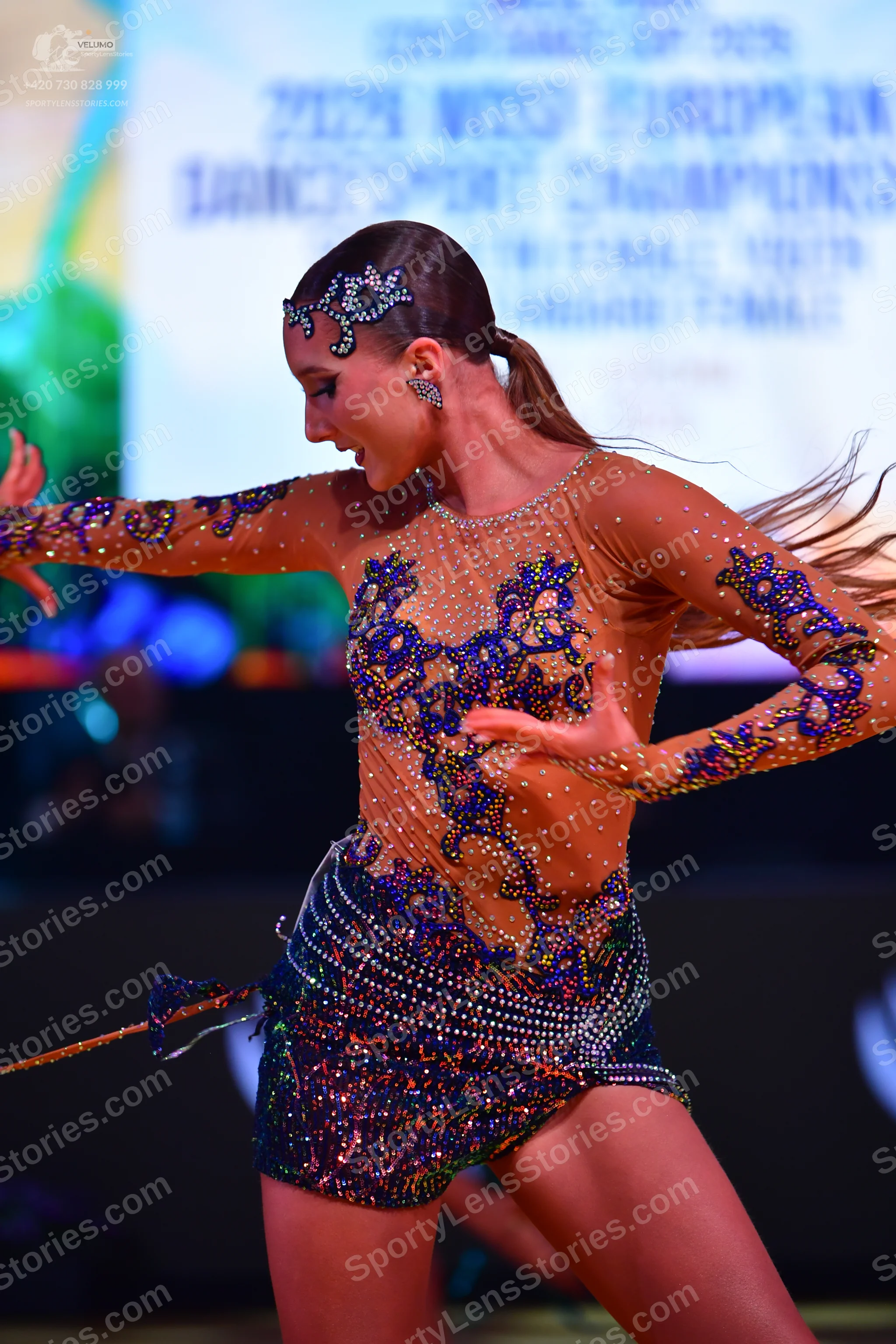 Dancesport competitor: Female dancer: latin dress made of nude-colored mesh/illusion fabric, heavily em