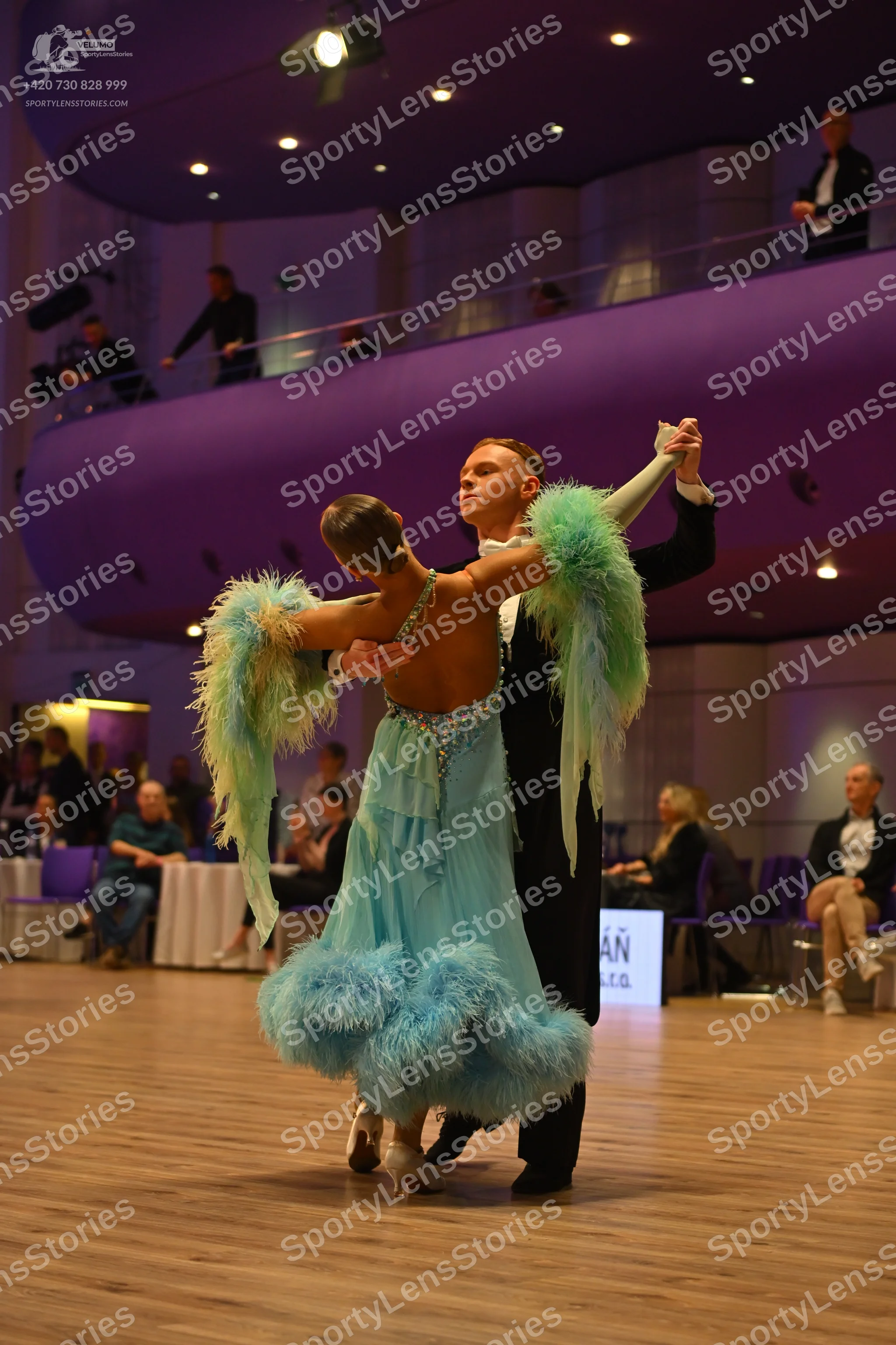 Dancesport competitor: Male dancer: black formal suit with a white shirt and white bow tie