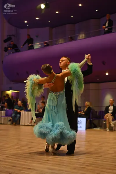Dancesport competitor: Male dancer: black formal suit with a white shirt and white bow tie