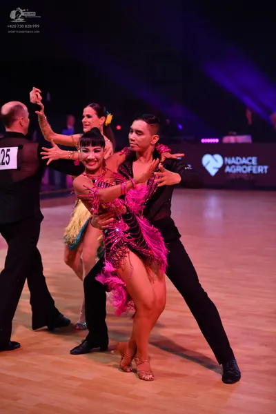 Dancesport competitor: Male dancer (left): black suit