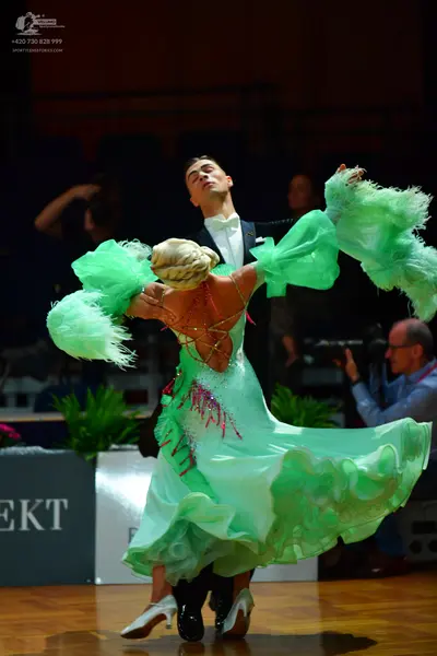 Dancesport competitor: Male dancer: black tuxedo with a white shirt and white bowtie