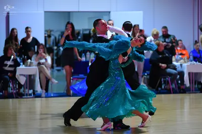 Dancesport competitor: Male dancer: black suit with a white shirt