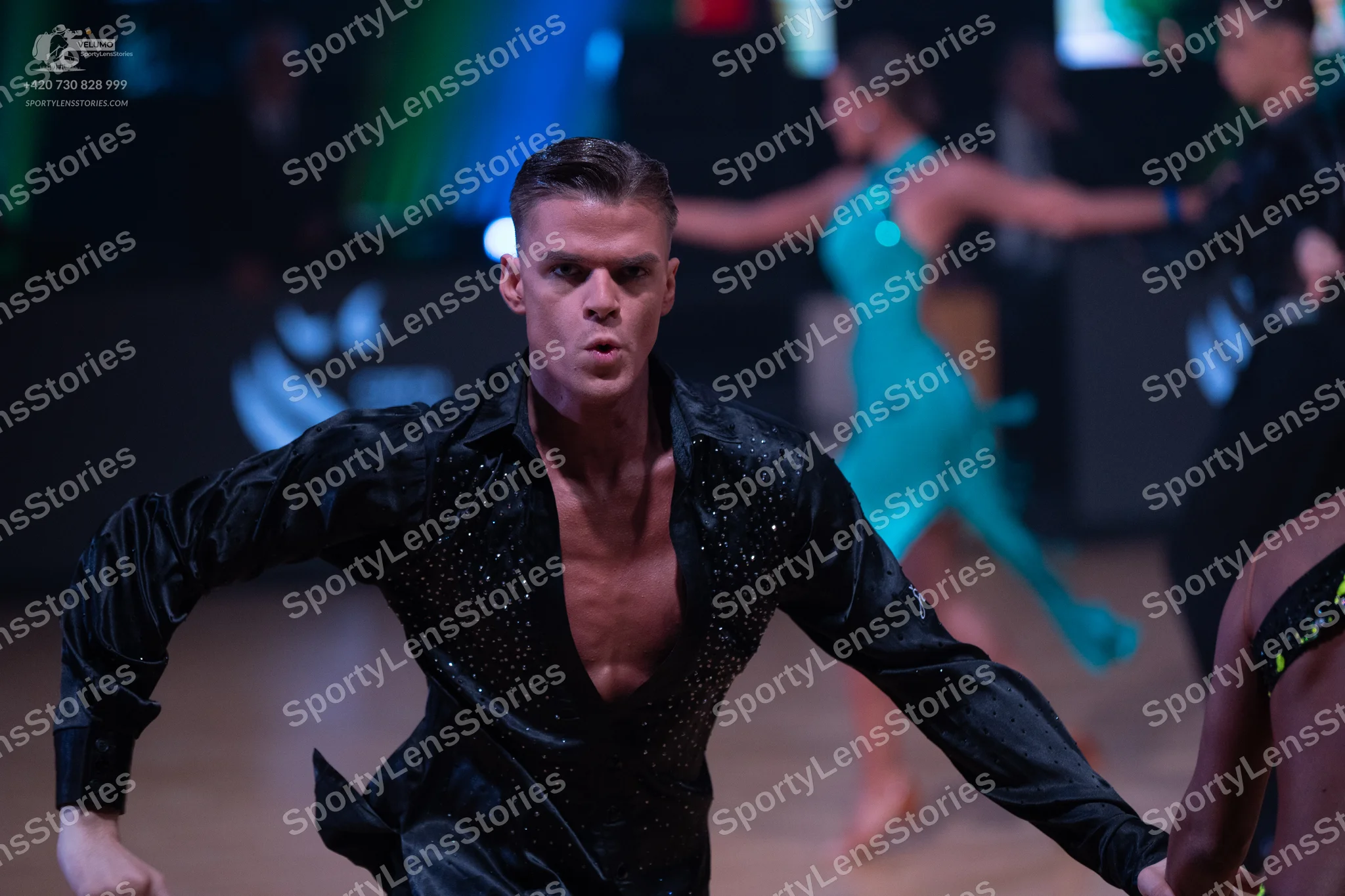 Dancesport competitor: Male dancer: black long-sleeved satin-like shirt with a deep V-neck and sequin e