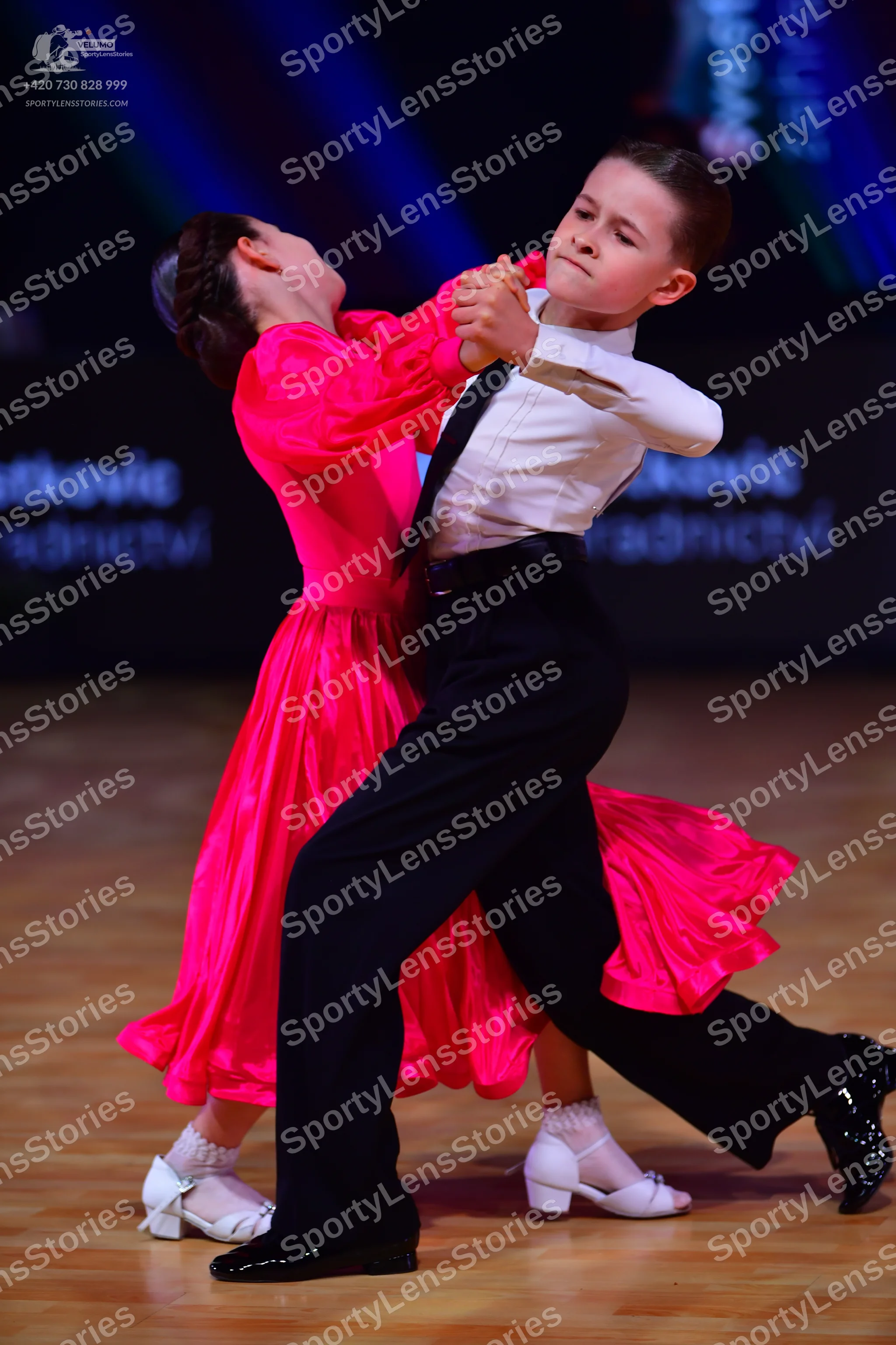 Dancesport competitor: Male dancer: white long-sleeved shirt, black trousers, and black shoes