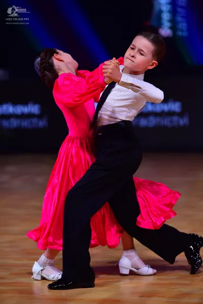 Dancesport competitor: Male dancer: white long-sleeved shirt, black trousers, and black shoes