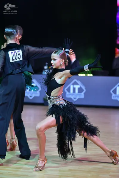 Dancesport competitor: Male dancer: black long-sleeved shirt and black trousers