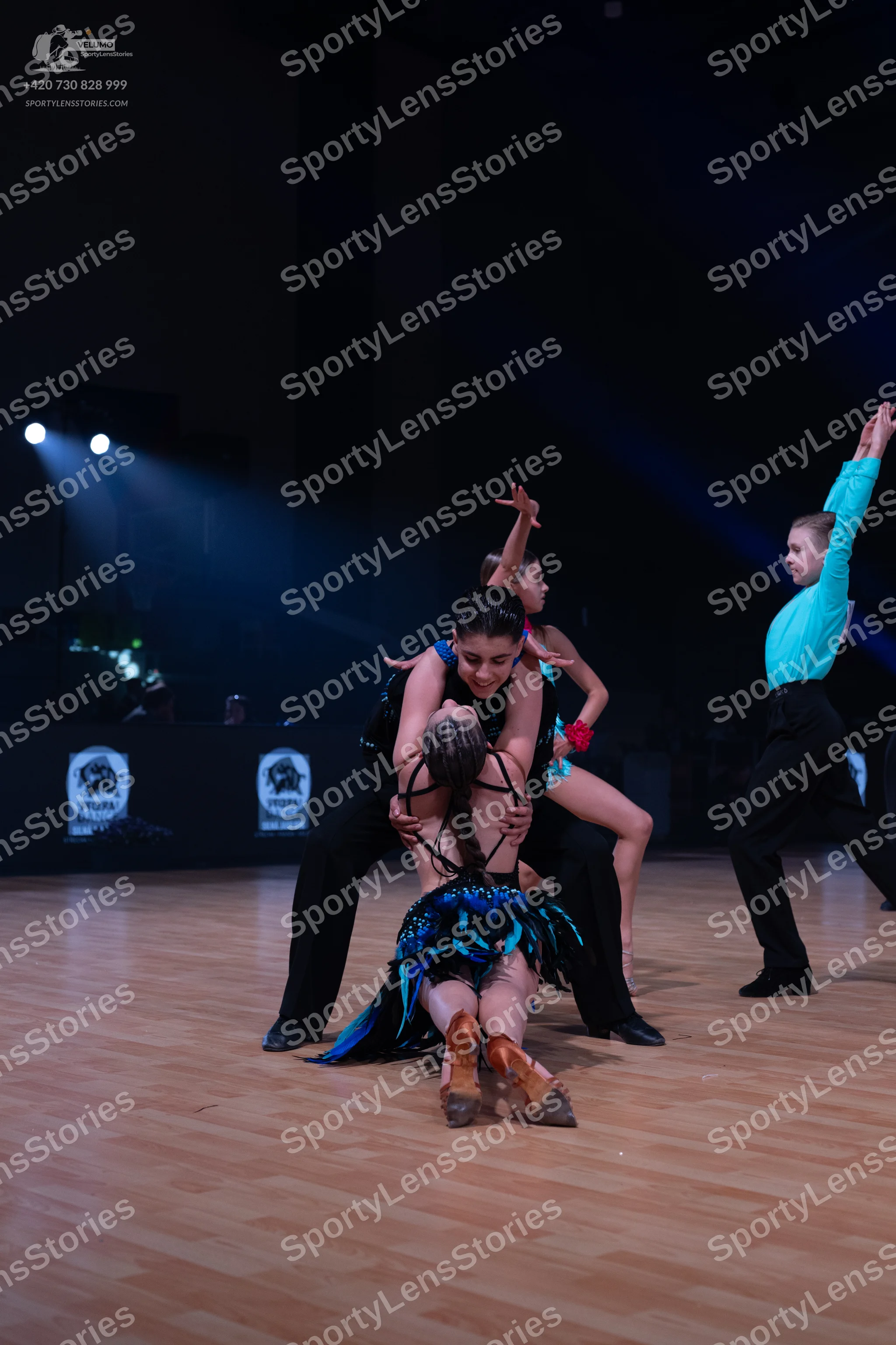 Dancesport competitor: Male dancer (left): black shirt and black trousers