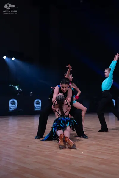 Dancesport competitor: Male dancer (left): black shirt and black trousers