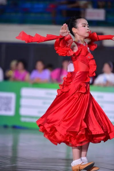 Dancesport competitor: Female** Red latin dress with fringe