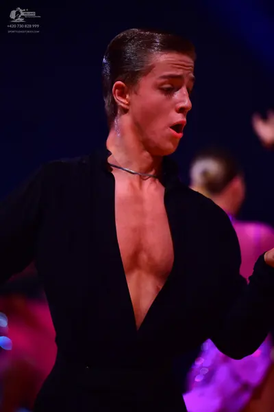 Dancesport competitor: Male dancer: black long-sleeved, deep V-neck Latin dance top