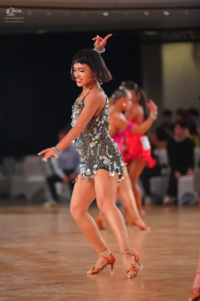 Dancesport competitor #48: Female dancer 1: dark/black latin dress heavily embellished with silver sequins 