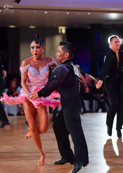 Dancesport competitor #13: Female dancer: pink latin dress with sequins and frills