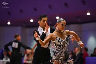 Dancesport competitor: Male dancer: black Latin dance shirt with a large silver/white sequin panel on t