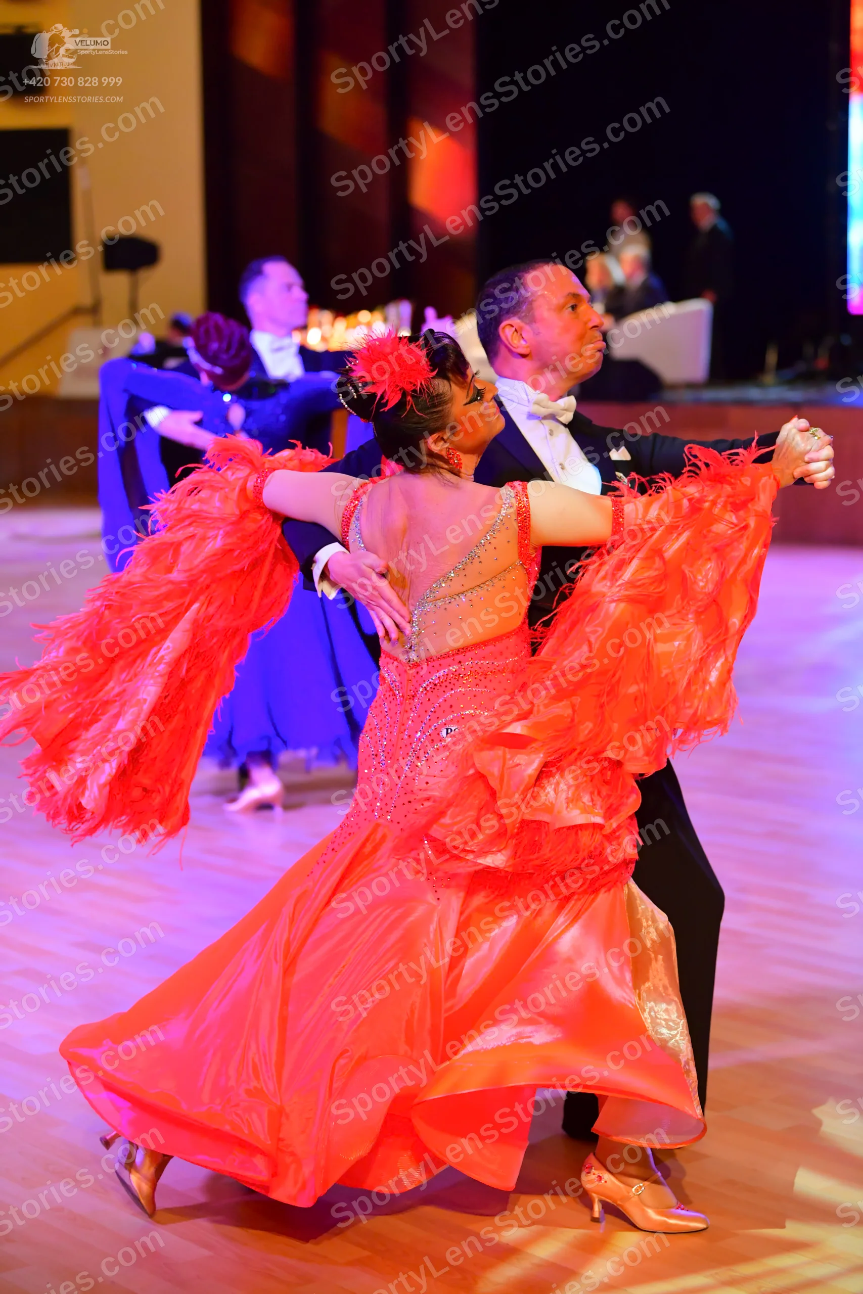 Dancesport competitor: ** Red Latin Dress
*   **Color:** Bright red
*   **Fabric:** Appears to be satin