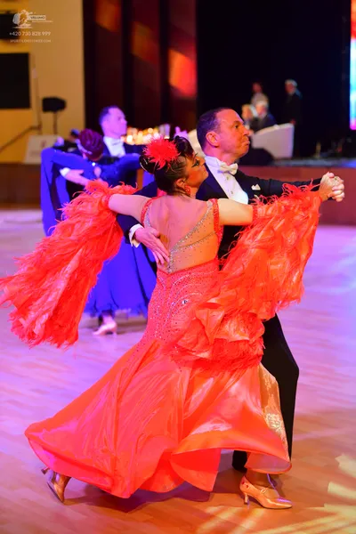 Dancesport competitor: ** Red Latin Dress
*   **Color:** Bright red
*   **Fabric:** Appears to be satin