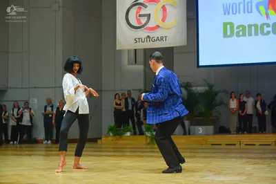 Dancesport competitor: Female dancer: white long-sleeved blouse and black leggings