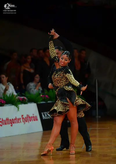 Dancesport competitor: Female dancer: leopard print Latin dress with a short flared skirt