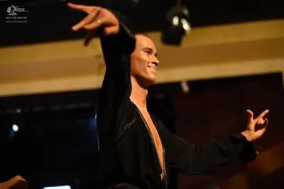 Dancesport competitor: Male:** Black tailsuit with sequin lapels