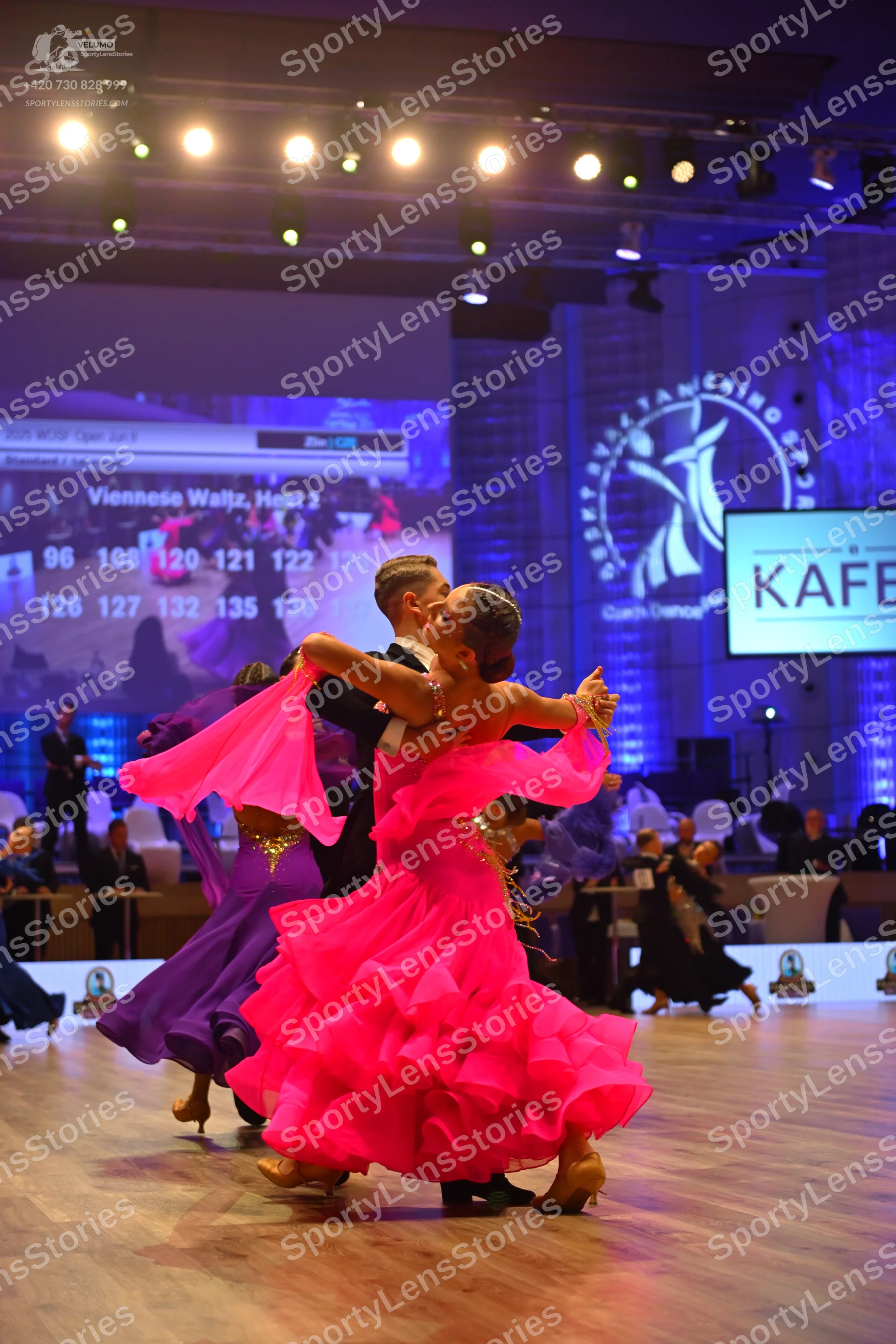 Dancesport competitor: Main female dancer: voluminous, multi-layered pink ruffled dress