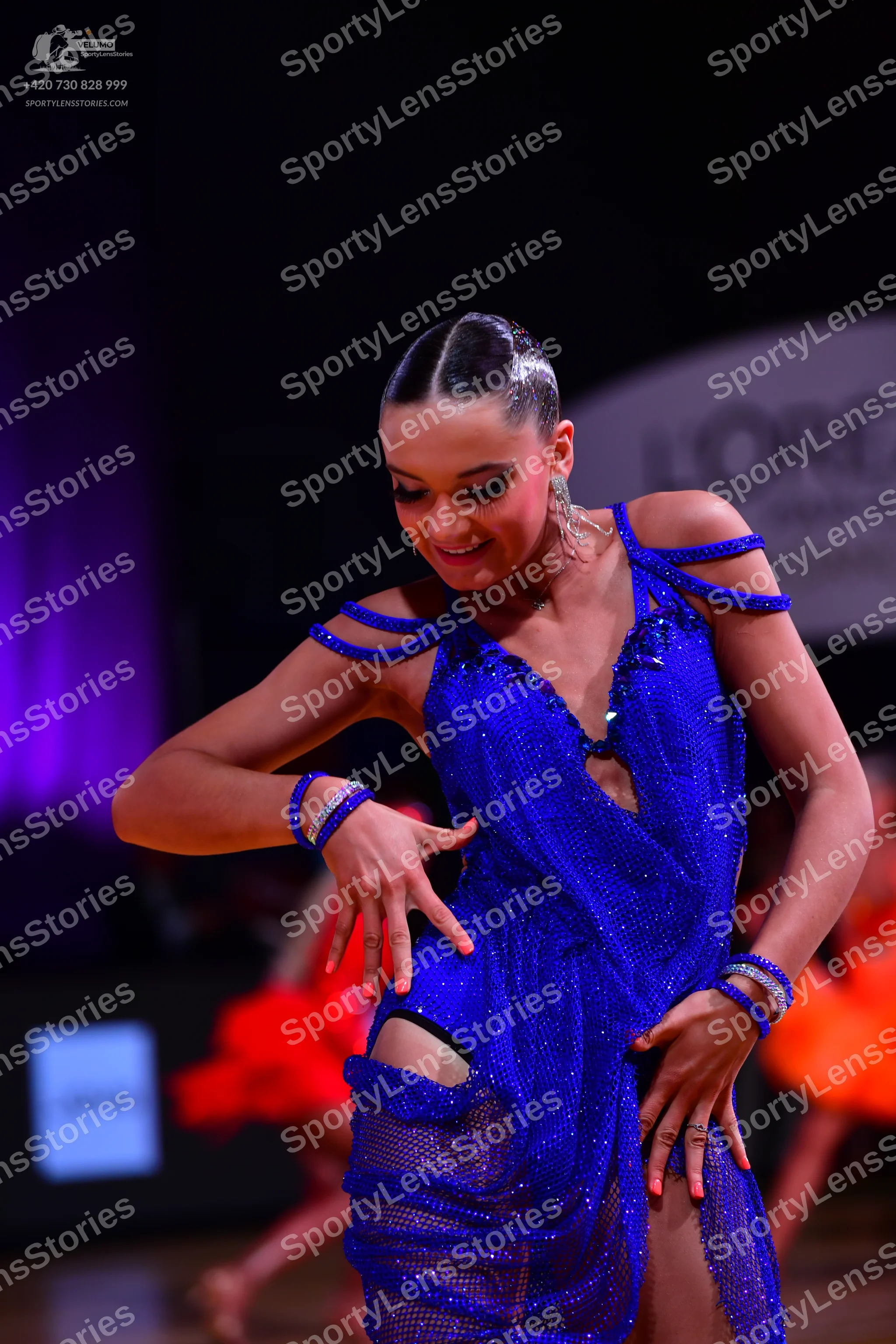 Dancesport competitor: Female dancer: blue sequined Latin dress with thin embellished straps and blue s