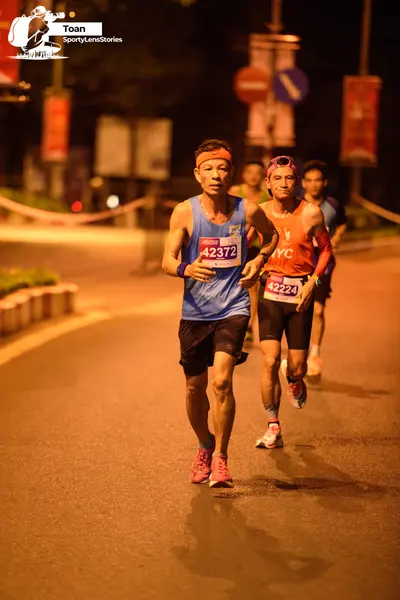 Marathon runner #42372, #42224: Runner 1: blue tank top, black shorts, pink shoes, orange headband, blue wristba