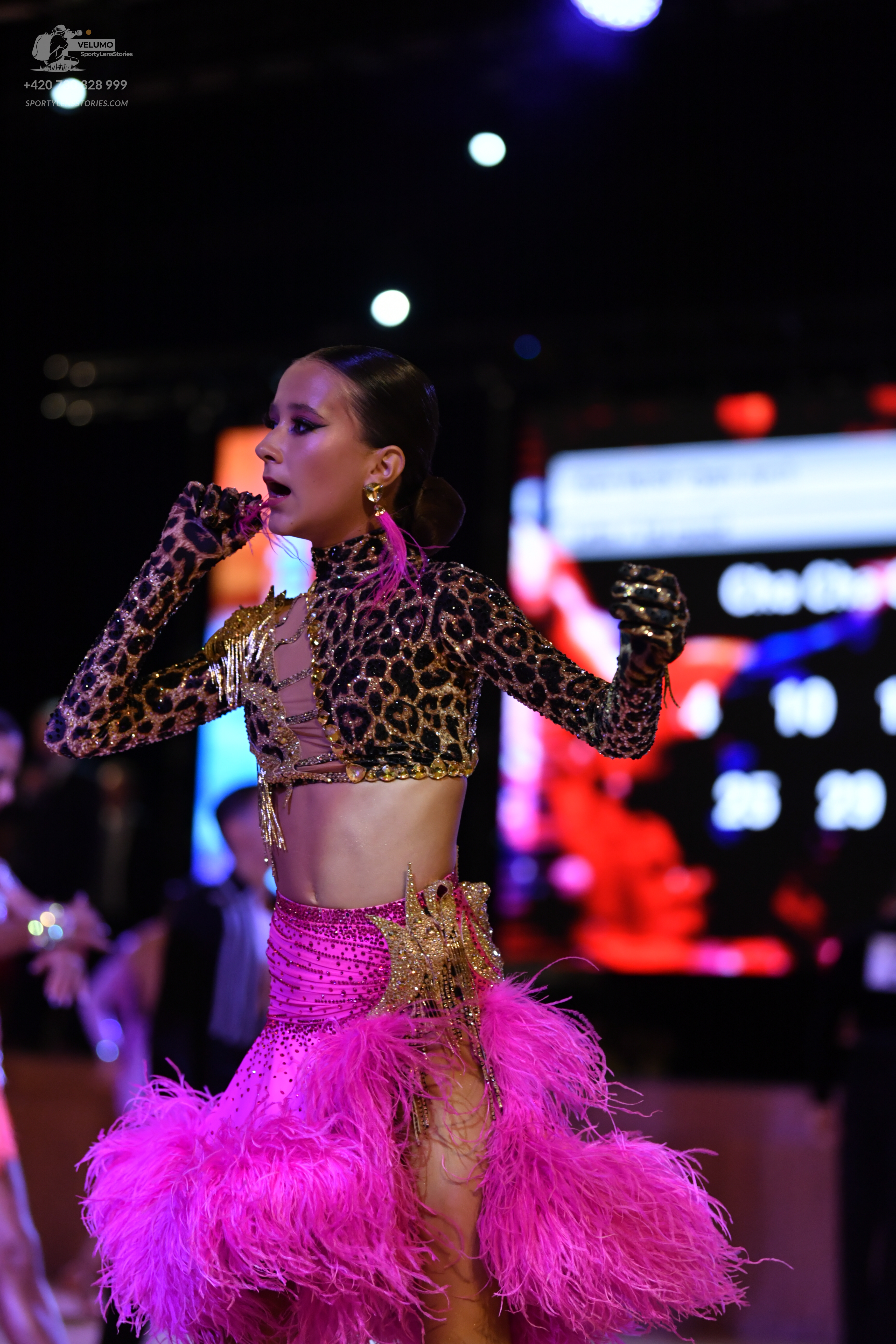Dancesport competitor: Female dancer: leopard print long-sleeved crop top with gold sequin embellishmen