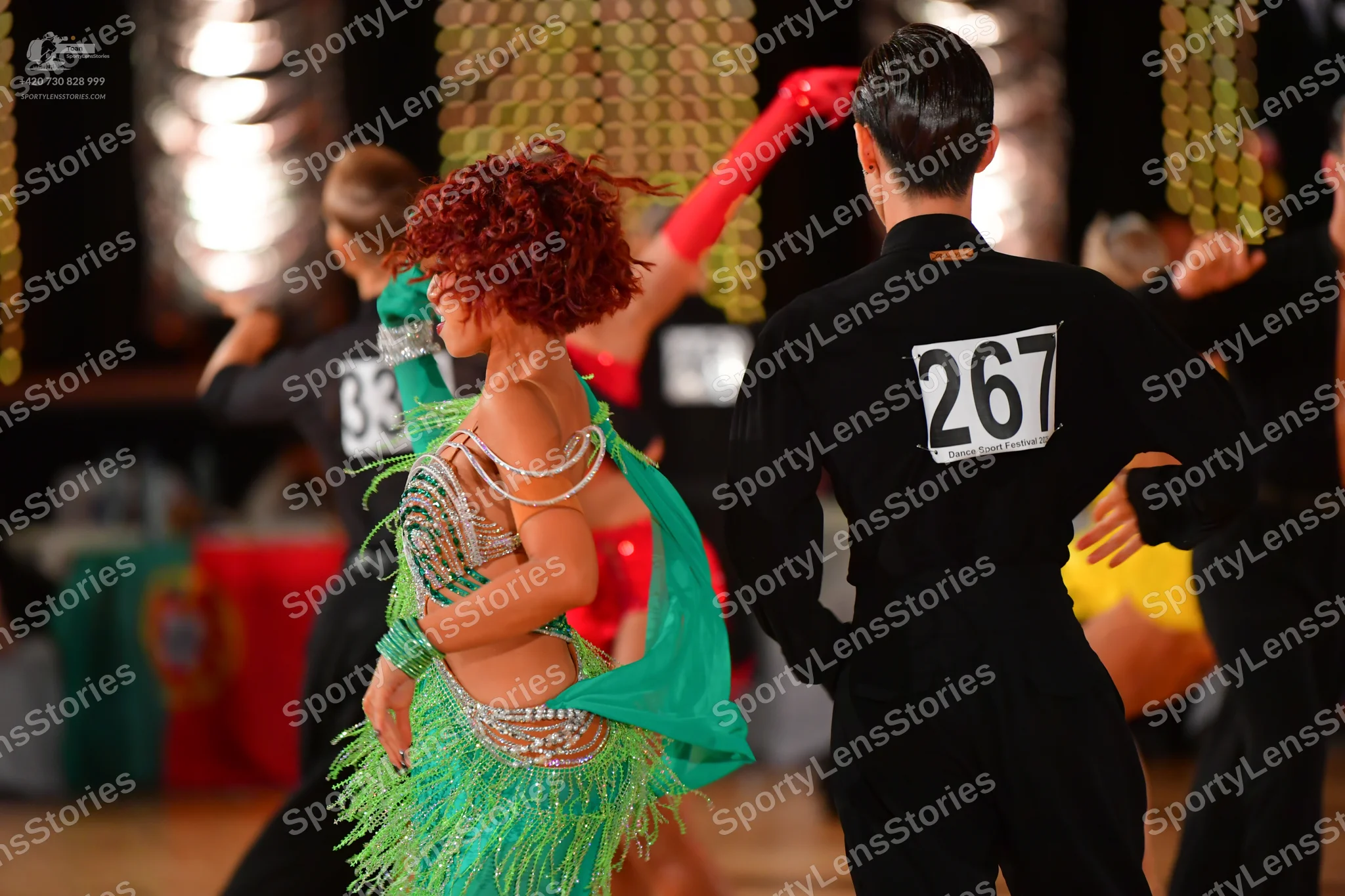 Dancesport competitor #33, #267: Female dancer: green Latin dance dress with long fringe and silver/crystal embel